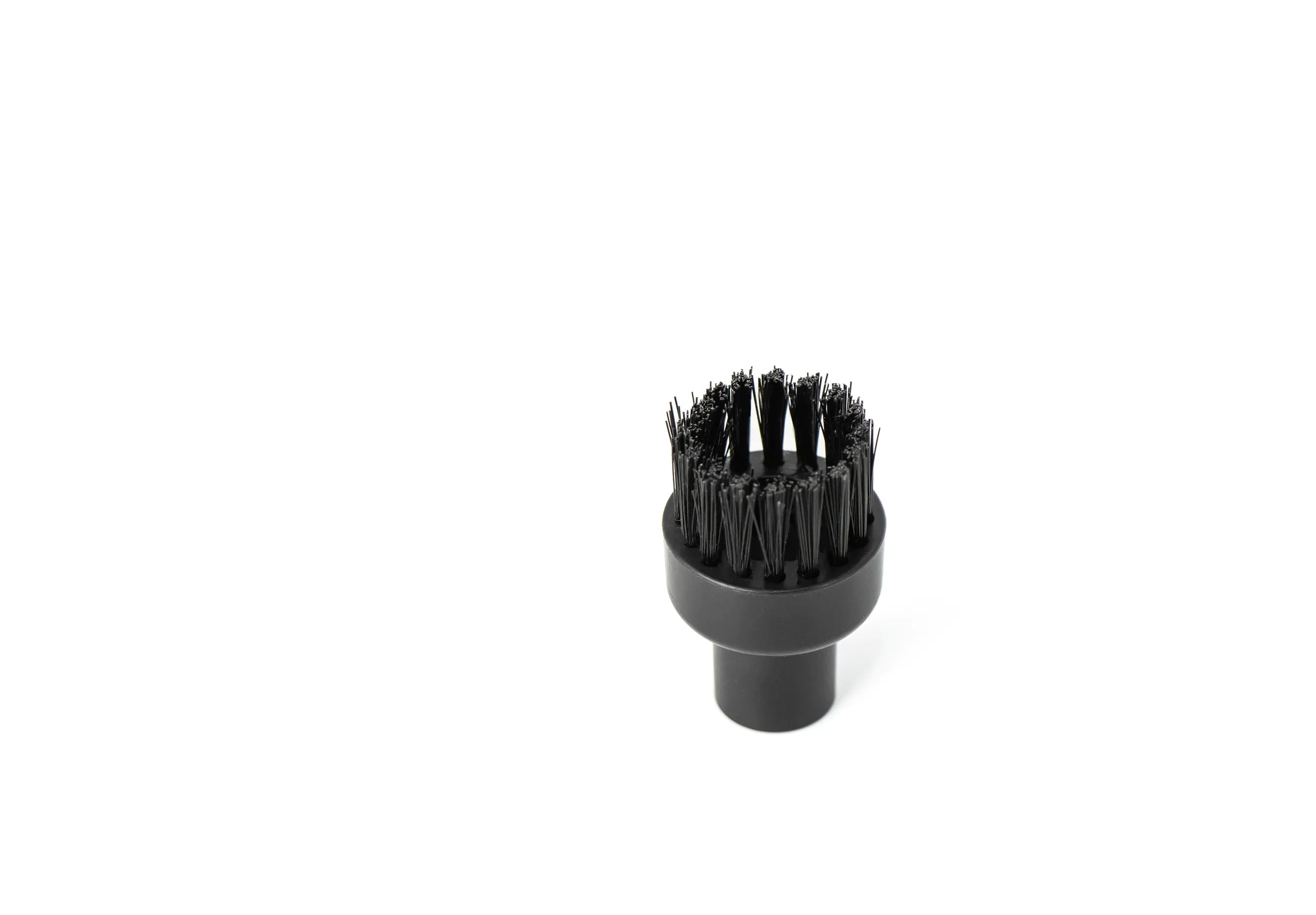 Black round vacuum brush attachment with stiff bristles on white background