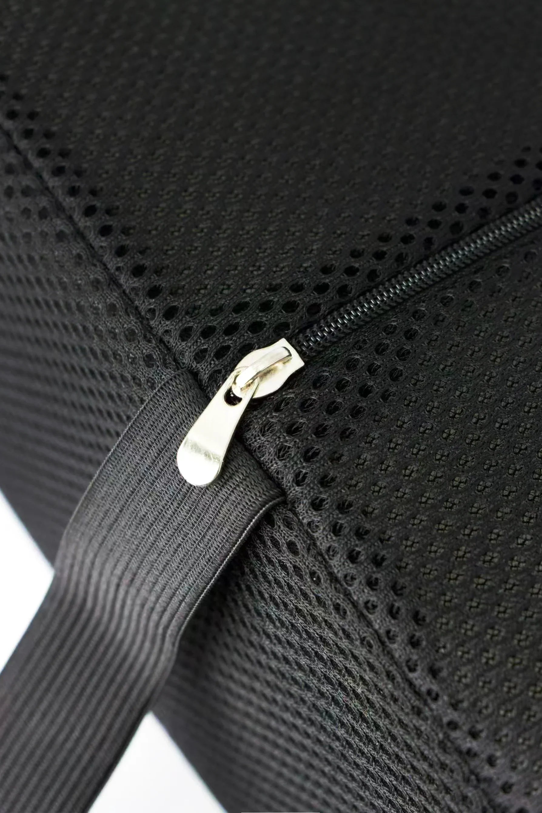 Close-up of black mesh fabric with a metal zipper and attached elastic strap