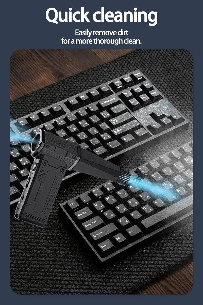 Handheld electronic air duster blowing dust off black computer keyboards on a textured mat