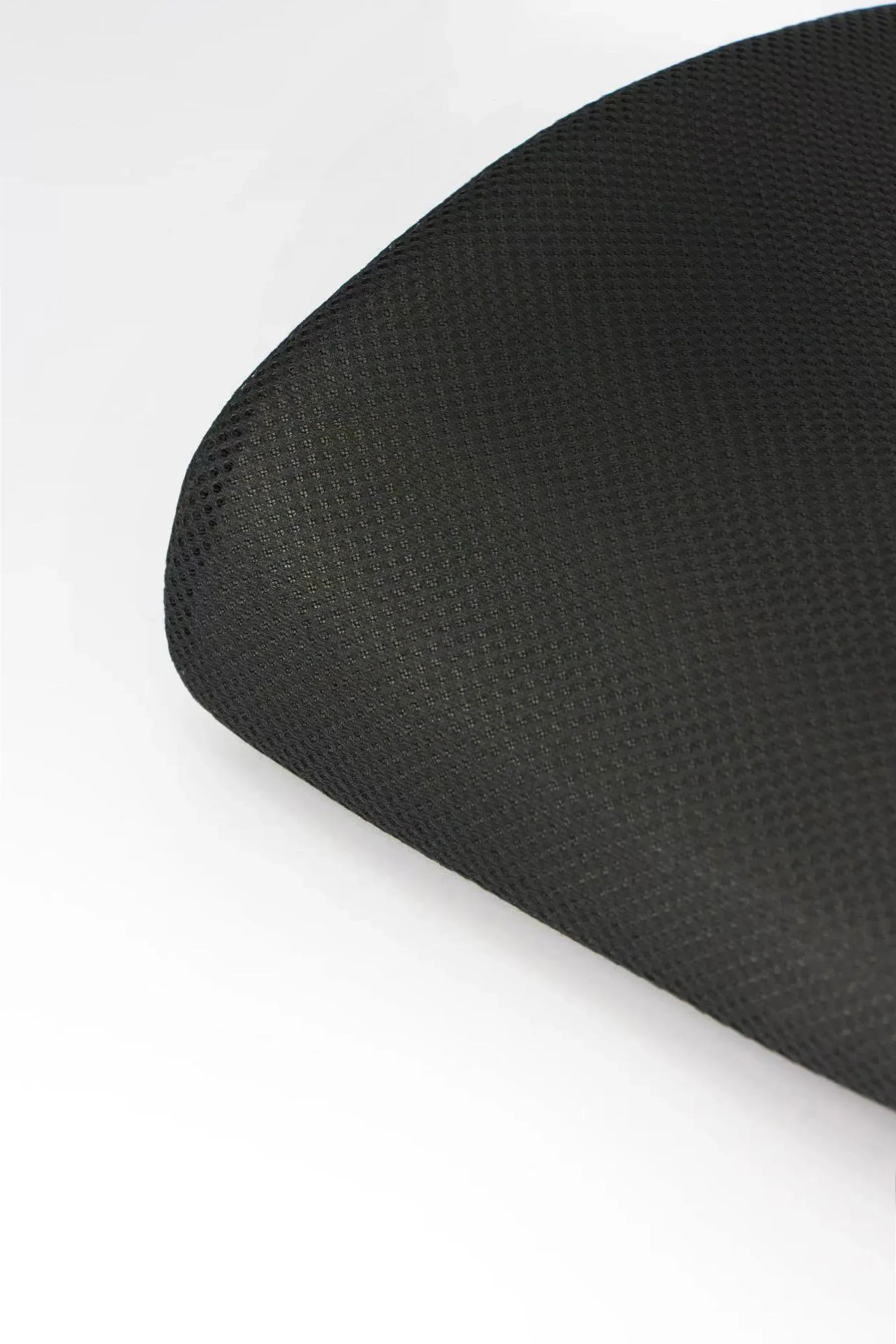Close-up of black textured fabric surface, possibly a seat cushion or chair upholstery